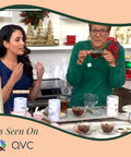 Two women demonstrate the Self Heating Mug With Phone Controlled Heat Settings And Wireless Charging Stand while enjoying tea.