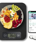 Smart Food Scale With Nutritional Calculator displaying fruit bowl weight, includes smartphone with nutrition app, 11lb capacity.