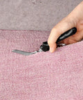 Hand using Heavy Duty Beast Of A Carpet Cutter Tool 8 Inch Carpet Scissors for precise carpet cutting, ergonomic handle visible
