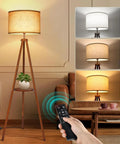 Wood Tripod Floor Lamp With Shelves, Dimmable LED Modern Floor Lamp With 4 Color Temperatures and Remote in a living room setting