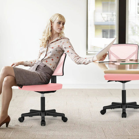 Woman sitting on Ergonomic Low Back Mesh Desk Chair With Rolling Wheels Armless Swivel Office Seat For Home Study Or Dorm Comfy Lumbar Support Compact Pink