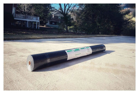 Heavy Duty Synthetic Roof Underlayment Roll 48 Inches Wide Delivers 1000 Sq Ft on a concrete surface, showcasing the roll's black waterproof material.