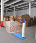 Heavy Duty Manual Stretch Film Dispenser With Pro Grade Wrap Bench Built Like A Tank To Crush Heavy Pallets and wrapped pallet in warehouse.