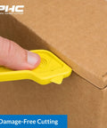 Heavy Duty Dual Head Concealed Safety Cutter Hits Different For Slicing Shrink Wrap Film Cardboard And Plastic Straps With Recessed Blades For Zero Slip Protection And No Sweat All Day Long in use on a cardboard box.