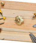 Vintage Brass Flower Cabinet Handle Single Hole Drawer Pull for Wardrobe and Cupboard Doors with tools on wooden surface