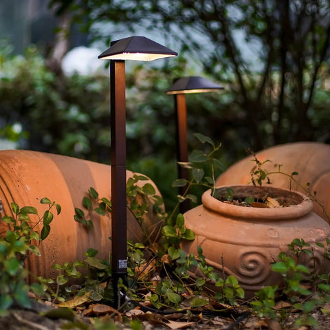Low Voltage Outdoor Pathway Lighting Kit With 0.6W LED 3100K Warm White 12V Metal Path Lights In Charcoal Brown beside garden pots