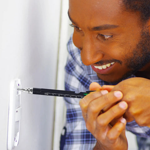 Man using Nine In One Multitool Pen Set Great Stocking Stuffers For Men Dad Boyfriend Husband From Daughter Cool Gadgets For Guys Who Have Everything Perfect Gift For Christmas And Everyday Use With Durable Aluminum Build And Sleek Design on a light switch