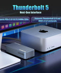 Hella Fast Eighty Gbps M Two Nvme Ssd Enclosure compatible with Thunderbolt Three and USB Four next to Apple desktop.