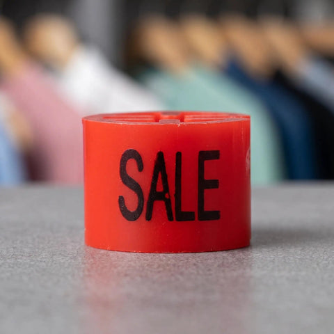 Red Sale Hanger Markers 200 Pcs High Visibility Coding Tags standing on a gray surface with blurred clothes in background