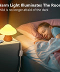 Wooden Mushroom Lamp With 16 Color Changing Options and Dual Remote Controls by a child's bed, creating a cozy night light