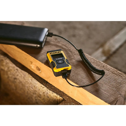 Laser Pocket Measure 12 m Handheld Distance Tool For Pros, Contractors, And DIYers, Compact And Durable Laser Measurer With Quick Readouts, Accurate Measurements, Ideal For Carpentry, Interior Design, And Renovations Model STHT77666-0 on wood plank