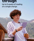 Young man holding a Hustle Free Pocket E Reader With Edge To Edge Color Display And Next Level Six Week Battery Life.