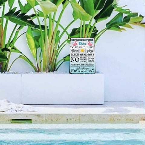 Pool Rules Sign Funny Metal Decor For Indoor Outdoor Use 12x8 Inch Durable Hanging Plaque displayed by a pool.