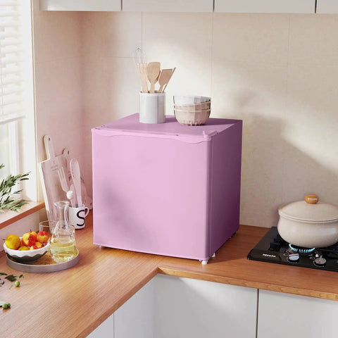 Slick 1.1 Cu Ft Compact Countertop Upright Freezer Featuring Smooth Temperature Dial And Handy Removable Shelf In Vibrant Pink on a kitchen countertop.