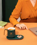 Keep Your Daily Java Straight Up Hot With This Electric Coffee Mug Warmer Boasting Five Smart Temp Settings And Auto Shut Off Across Any Desk Keeping Beverages Smooth Without The Cold Cup Blues, elegant green mug on modern warmer.