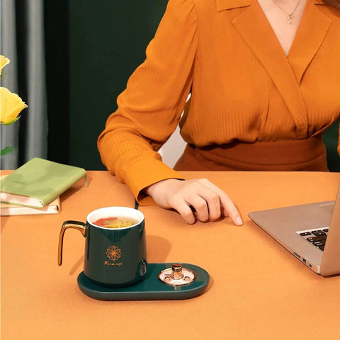 Keep Your Daily Java Straight Up Hot With This Electric Coffee Mug Warmer Boasting Five Smart Temp Settings And Auto Shut Off Across Any Desk Keeping Beverages Smooth Without The Cold Cup Blues, elegant green mug on modern warmer.