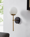 Total Home Flex Super Sleek Led Wall Sconce With Flicker Free Eye Care Lighting That Slays Any Decor Vibe While Delivering Soft Ambient Glow And True Bang For Your Buck Efficiency For Bedrooms And Living Rooms in black and brass finish, mounted on a wall.