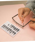 Person using Assorted Eyeglass Repair Screws Kit For Sunglasses And Watches, Durable Metal Fasteners For Quick Repairs On The Go on glasses