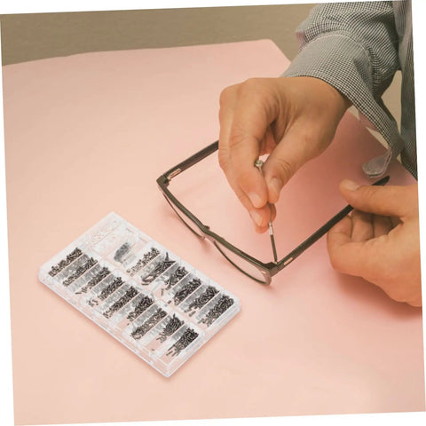Person using Assorted Eyeglass Repair Screws Kit For Sunglasses And Watches, Durable Metal Fasteners For Quick Repairs On The Go on glasses