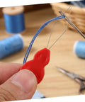Gourd Shaped Needle Threaders 100 Pack Plastic Threading Tools For Hand Sewing And Embroidery, Effortless Threading, Versatile Use For Travel, Grab And Go DIY Crafts, And Quick Needle Tasks red plastic threader with thread in needle