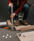 Person assembling furniture using 100 Pack White Plastic And Stainless Steel Shelf Pegs For Wine Cabinets Bookcases And Furniture