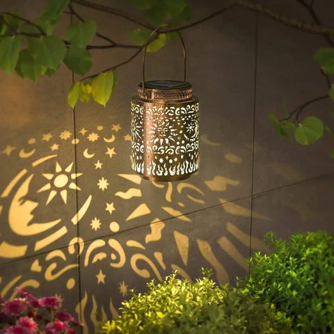 2 Pack Outdoor Solar Lanterns With Hanging Lights Waterproof Metal Sun Moon Star Pattern In Gold Finish Patio Porch Yard Backyard Table Garden Decor Solar Powered Garden Lights For Warm Ambience illuminating garden