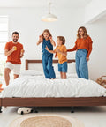 Family enjoying time on a bed equipped with Heavy Duty Adjustable Bed Support Legs 6 Pack Metal Bed Risers For Queen King Frames Extending 7 To 11 Inches To Kick Sagging To The Curb And Smooth Out Creaky Platforms Fast.