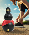 900ml Hydration Bottle With Gourd Inspired Shape For Hikers And Campers next to woman tying shoe outdoors.