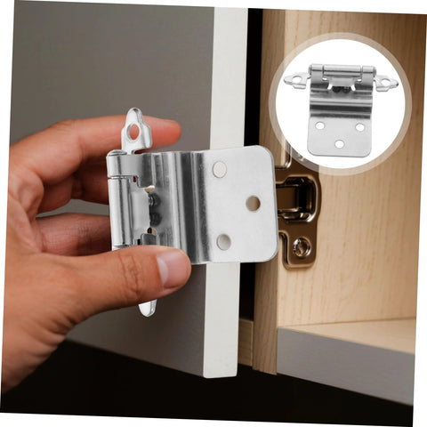Front view: hand holding a silver Cabilock soft-close inset cabinet hinge with mounting plate for kitchen cabinets