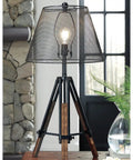 Leolyn Urban Industrial Tripod Table Lamp With Adjustable Height Wire Mesh Shade Black And Brown Finish on desk near window