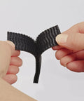 Hands holding Beefy Black Scotch Extreme Fasteners 10 Ft By 1 In Heavy Duty Velcro Bond That Grips Up To 10 Lbs, weatherproof