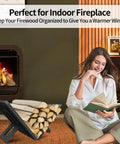 Indoor Outdoor Firewood Rack Portable Wood Log Holder Built From Black Steel beside a lit indoor fireplace with woman reading
