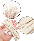Hand holding 16 cm cotton wicks and 2 cm ceramic holders from Durable Ceramic Oil Lamp Holder Kit With 10 Holders And 20 Cotton Braided Replacement Wicks, 2 Cm Holders And 16 Cm Wicks, DIY Outdoor Tiki Torch Lighting Set For Backyards Camps And Patio Hangouts.