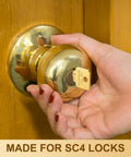 Person holding a door knob with a "Do Not Duplicate" gold key inserted. Bulk 50 Pcs Do Not Duplicate Metal Key Blanks For House Door Locks Gold SC4 Replacement Keys.