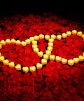 Romantic Decor Bundle With 3000 Artificial Rose Petals And 48 Heart Flameless LED Tea Lights Battery Operated Candles For Valentines Day Wedding Anniversary Party And Cozy Home Vibes arranged in heart shapes on petals