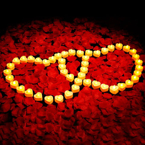 Romantic Decor Bundle With 3000 Artificial Rose Petals And 48 Heart Flameless LED Tea Lights Battery Operated Candles For Valentines Day Wedding Anniversary Party And Cozy Home Vibes arranged in heart shapes on petals