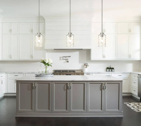 Clear Glass Pendant Light With Brushed Nickel Finish in a modern kitchen over gray island