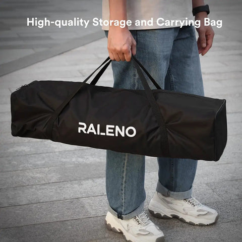 Person carrying a Softbox Lighting Kit 20x28-Inch With Dual 50W Daylight LED Bulbs 5500K TLCI 97 in a black bag with handles