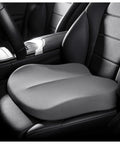 Upgrade Your Ride With This Sleek Grey Non-Slip Car Booster Seat Cushion Perfect For Mini Cooper SE Convertible John Cooper Works Electric And Other Trucks SUVs Or Cars To Boost Driver Height Improve Posture And Enjoy Smoother Longer Drives Today - Grey foam seat cushion on black leather car seat.