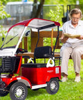 No Sweat Electric Mobility Scooter For Adults And Seniors With 28 Mile Range And 12 Mph Top Speed Hella Tough Frame parked near a reading woman.