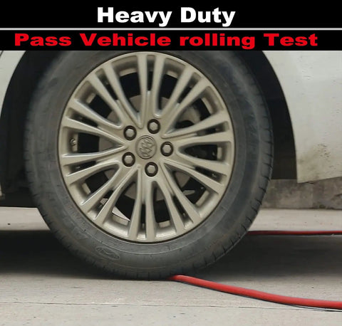 Car wheel rolling over Beefy All-Weather 1/4-Inch By 25-Foot Air Hose With 300 PSI Rating, showing durability and flexibility.