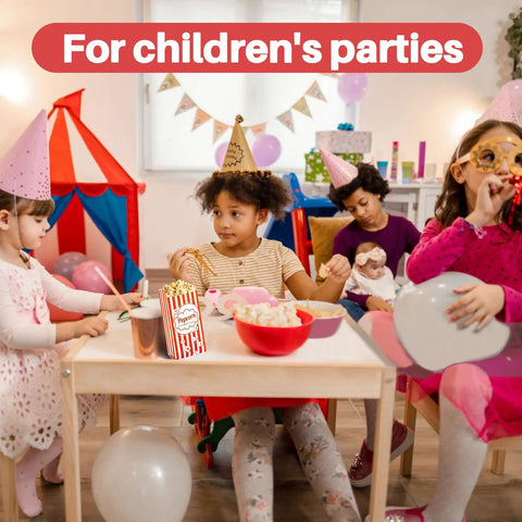 Children's party scene with kids in costumes, eating popcorn from red striped 100 Disposable Popcorn Bags 1oz Paper Bags For Popcorn And Kernels Mini Containers Perfect For Movie Nights Halloween Christmas Carnival Games Party Supplies And Popcorn Machine Accessories, with a tent in the background and balloons.