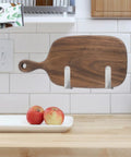 Stainless Steel Wall Mounted Lid Rack And Cutting Board Holder For Pan Lids installed in kitchen with wooden cutting board.