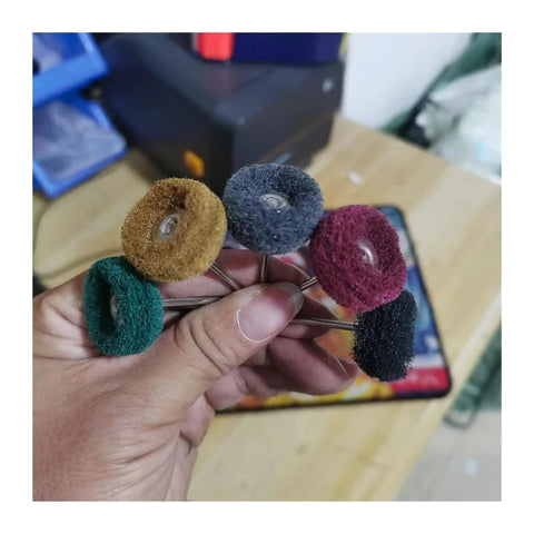 Five nylon abrasive wheels in hand, various colors for precision polishing. Must-Have 10-Piece Nylon Abrasive Wheel Kit With 120 To 600 Grit For Precision Polishing And Buffing Metal Surfaces Using 2.35 Or 3mm Shank Rotary Tools.
