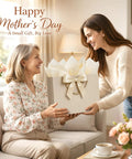 Two women exchanging a gift bag with ribbon and tissue papers on Mother's Day, with focus on the aesthetic gift presentation.
