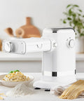 GVODE Electric Pasta Maker Machine, 3 In 1 Pasta Roller And Cutter Set, White, close-up with fresh pasta and flour on countertop.