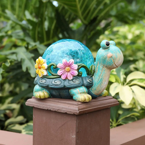 Garden Turtle Statue Outdoor Decor Resin Figurine with Glass Solar Lights on a fence post in a garden setting.