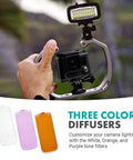 Person holding GoPro with Underwater LED Video Light 700 Lumen High Power Waterproof, showing three color diffusers.