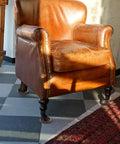 10 Pack Furniture Caster Cups With Plush Felt Bottom Anti Skid Floor Savers under a brown leather armchair in sunlight.
