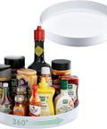Two Pack White 11.8 Inch Lazy Susan Turntable With Slick Three Sixty Spin And Reliable Nonslip Base For Hassle Free Refrigerator Cabinet Spice Rack Setup with assorted sauces and spices.